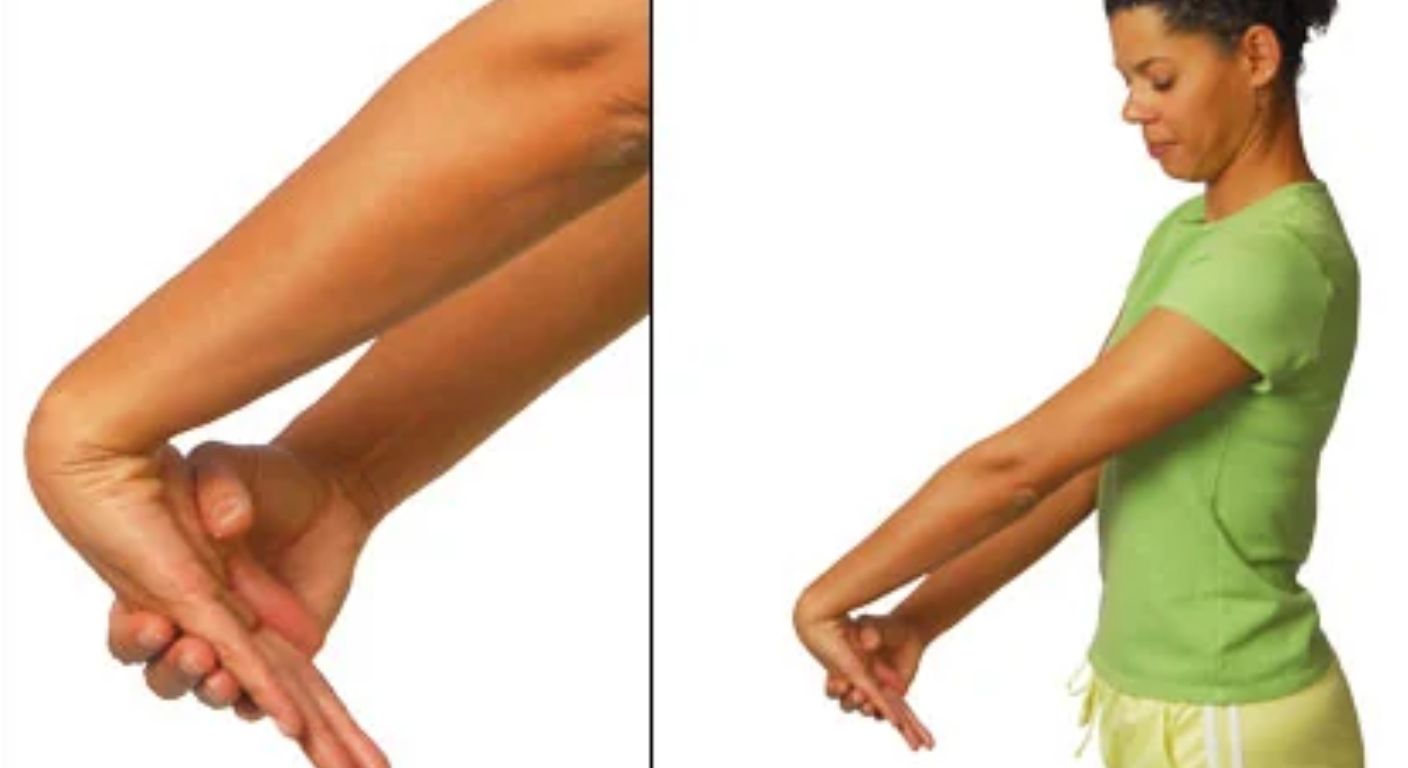 Wrist extensor stretch: arm straight, palm facing down, other hand gently pressing the back of the hand so the fingers point to the floor